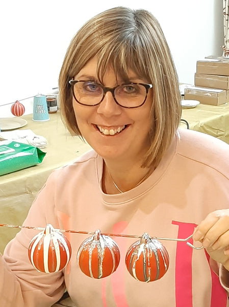 Rachael showing off her hand painted baubles at the Baubles and bubbles party in Stotfold