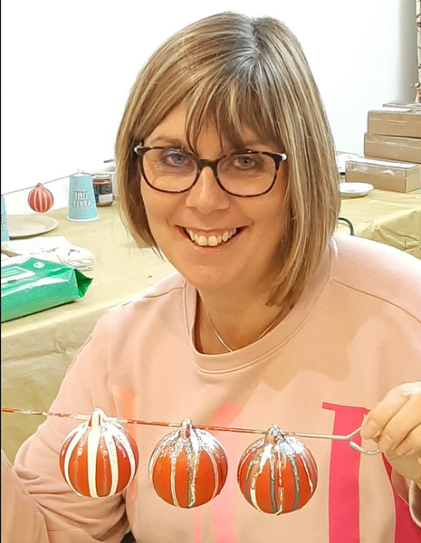 A baubler proudly showing off her traditional red, white and glittered creations