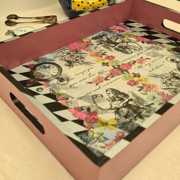 Alice in Wonderland pink serving tray. Uniquely decorated, painted and decoupaged with a black and silver harlequin pattern and Alice design. Unique, handmade creation by Shel's Shabby Chic