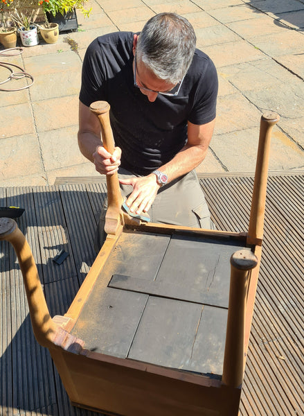 Andrew preparing his vintage cabinet at a 1-to-1 furniture painting for beginners workshop in Stotfold