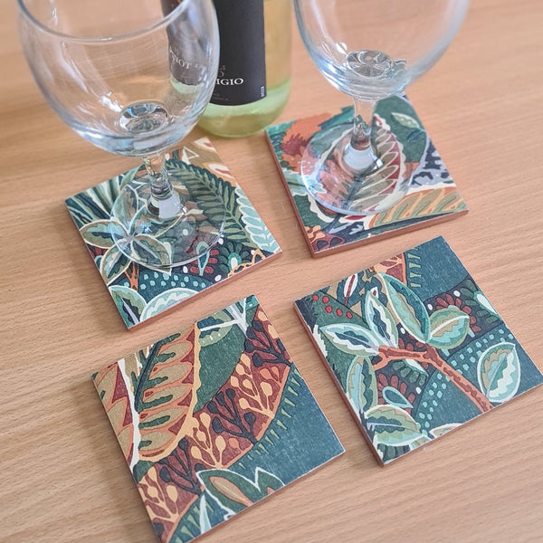 Nature's Exhibitionists handmade coaster set displaying bold maximalist design with layered textures and rich tones