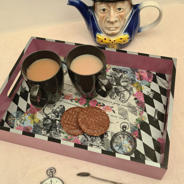 Alice in Wonderland serving tray styled on a coffee table with Mad Hatter teapot, tea and biscuits.