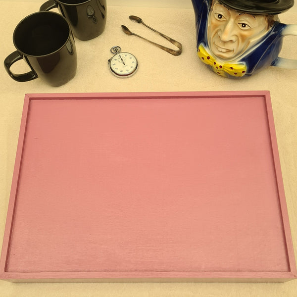 Reverse of Alice in Wonderland serving tray styled on a coffee table with coordinating decorative accessories.