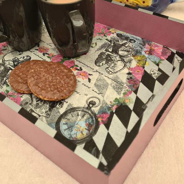Close-up of hand-painted black and metallic silver harlequin detailing on an Alice in Wonderland serving tray.