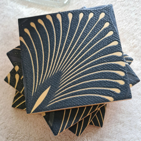 Art Deco Fan detail on handmade ceramic coasters with bronze metallic edging.