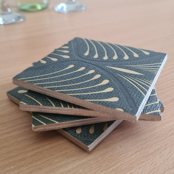 Stacked set of 4 handmade ceramic coasters featuring an elegant geometric Art Deco fan design and metallic edges