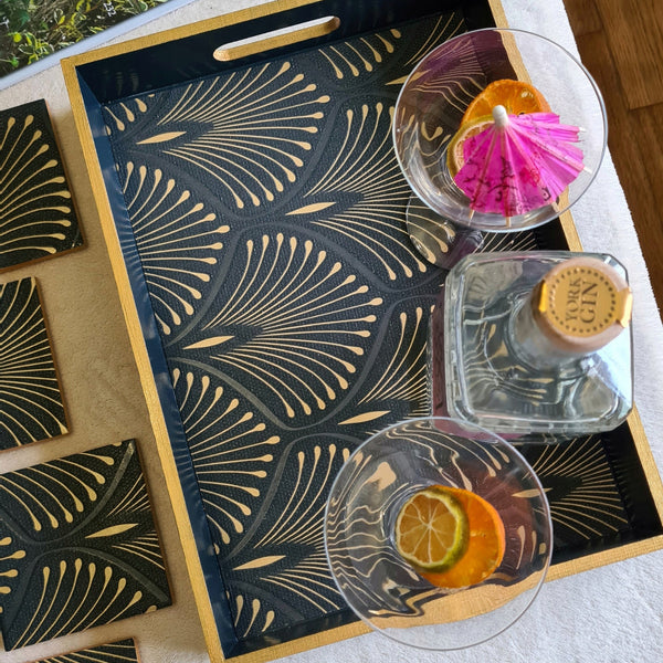 Above view of geometric Art Deco fan design on a handcrafted deep blue wooden serving tray with bronze edging.