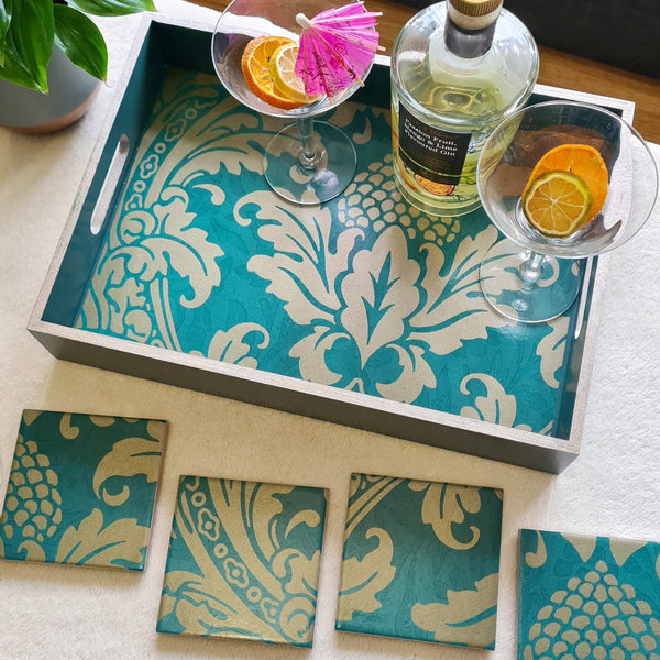 Teal Baroque serving tray and matching ceramic coasters styled as a statement piece on a coffee table with cocktail glasses and a bottle