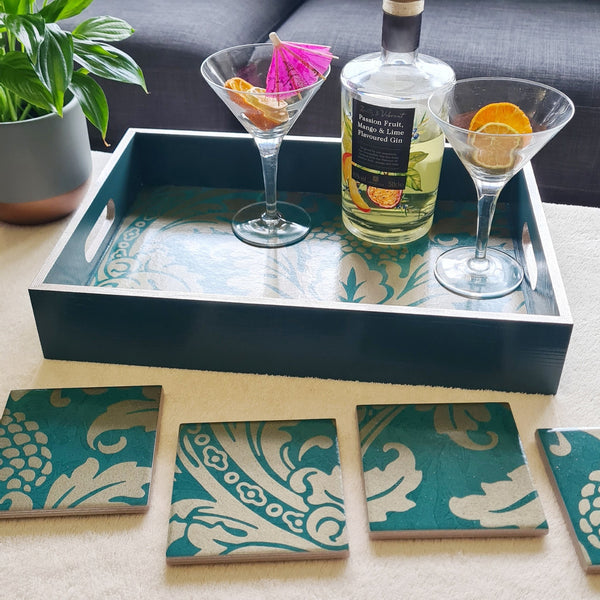 Teal Baroque serving tray styled as a statement piece on a coffee table with coordinating home accessories.