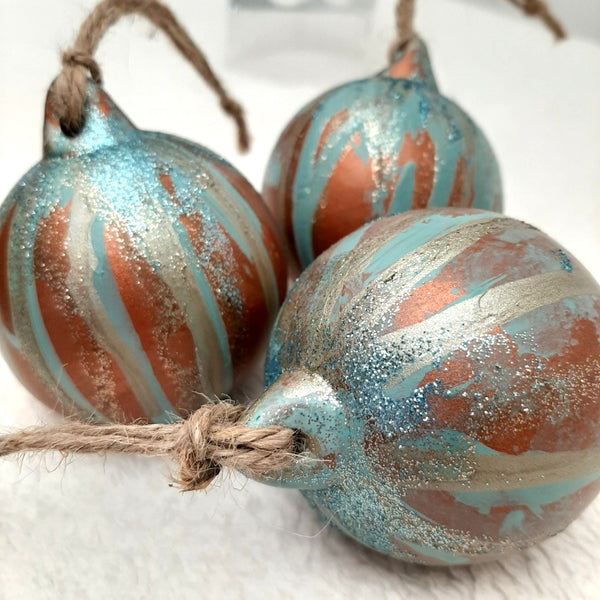Bespoke copper and blue hand-painted Christmas baubles with contrasting drizzle, sparkling glitter