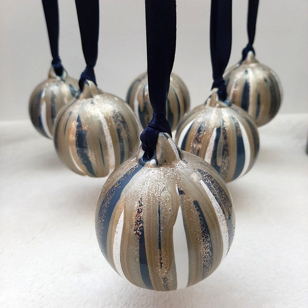 A set of six custom painted ceramic baubles, made to order by The Furniture Bureau.
