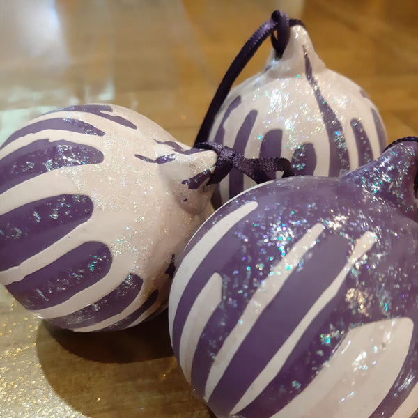 Bespoke pink and purple hand-painted Christmas baubles with decorative drizzle, glitter detail and coordinating ribbon