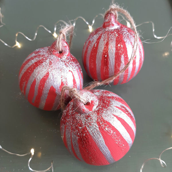 Bespoke red hand-painted Christmas baubles with decorative drizzle, glitter detail