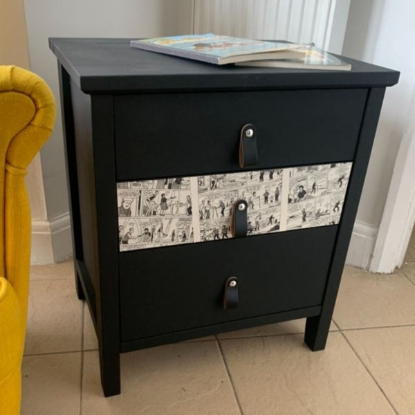 Transformed furniture after a 1-to-1 Workshop, showing a black three drawer chest with black leather handles and magazine decoupaged drawer front, achieved by a beginner.