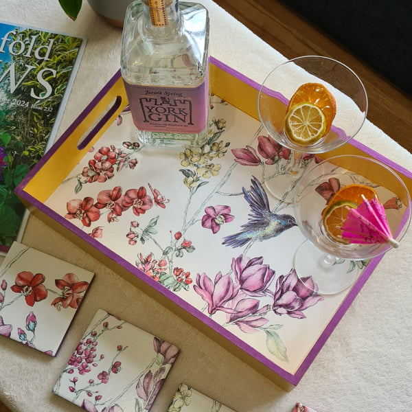 Handcrafted deep yellow wooden serving tray decorated with a colourful hummingbird and floral design with metallic violet edging.
