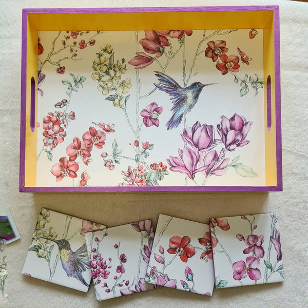 Deep yellow handcrafted wooden serving tray with integrated handles, hummingbird floral design and metallic violet edging. Coasters available separately.