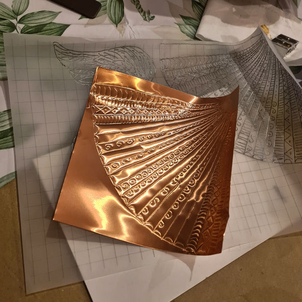 Close-up of decorative embossed copper detail on a handmade Copper Angel Christmas decoration.