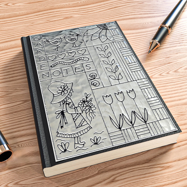 Silver A6 journal with a handmade aluminium embossed cover created using a beginner metal embossing kit.