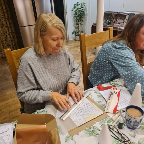 Lady creating her template in a metal embossing class in Stotfold.