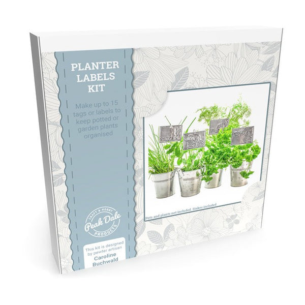 Embossing craft kit showing handmade embossed aluminium plant labels identifying herbs in garden pots.