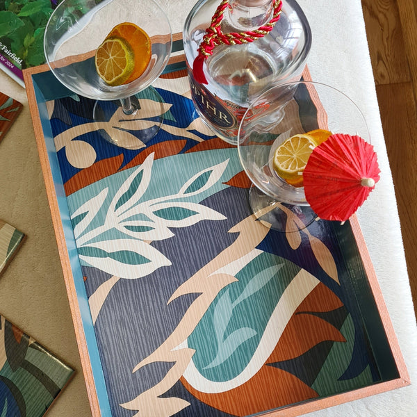 Colourful Retro Leaf serving tray styled as a statement piece on a coffee table with cocktails.