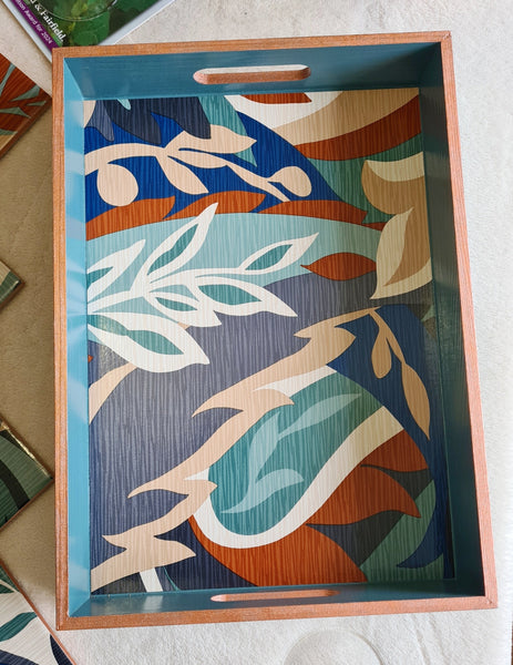 top view of bold colourful retro leaf design on a handcrafted deep teal wooden serving tray.