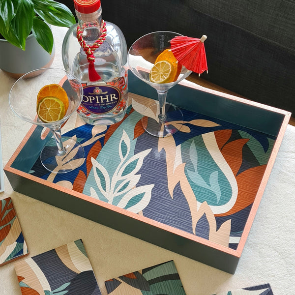 Handcrafted deep teal wooden serving tray decorated with a bold retro leaf design and metallic copper edging.