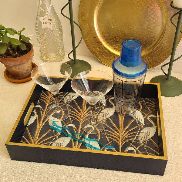 Angled view of navy wooden serving tray decorated with Angel Strawbridge Nouveau Heron design and metallic bronze edging.