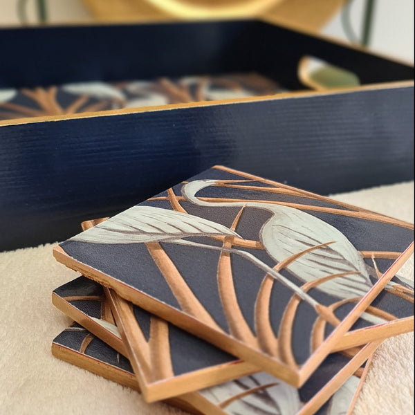 Navy wooden serving tray decorated with Angel Strawbridge Nouveau Heron design and metallic bronze edging, with stacked matching coasters, available separately.