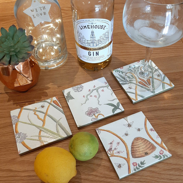 Handmade Chateau Potagerie ceramic coasters styled on a coffee table with lemon, lime and a bottle.  Totally unique tableware.