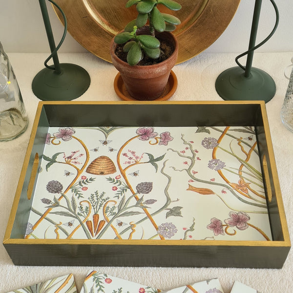 Close-up of The Chateau Potagerie botanical design and metallic gold edging on a handcrafted olive green wooden serving tray.