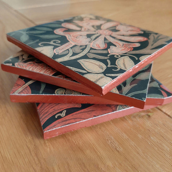 Stack of handmade William Morris Compton ceramic coasters showing their hand-finished edges.