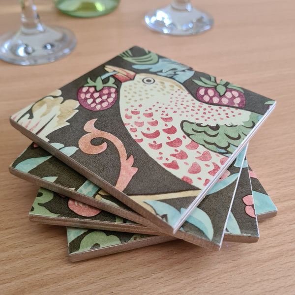 Stacked set of four handmade William Morris Strawberry Thief ceramic coasters in Chocolate Brown.