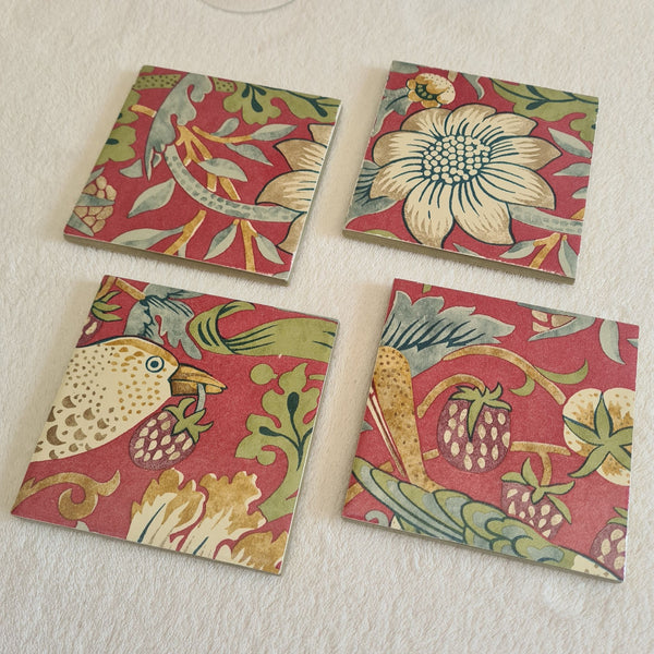 strawberries, flowers and foliage on a set of 4 handmade William Morris Strawberry Thief Crimson Red coasters.