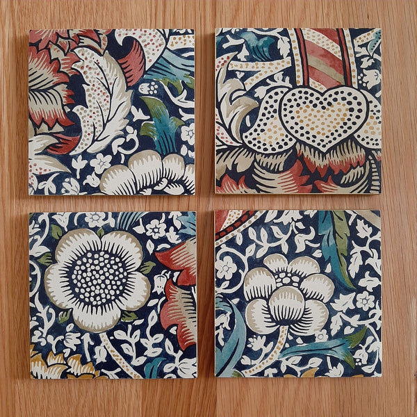 Handmade William Morris Wandle ceramic coasters with rusty red metallic edging.