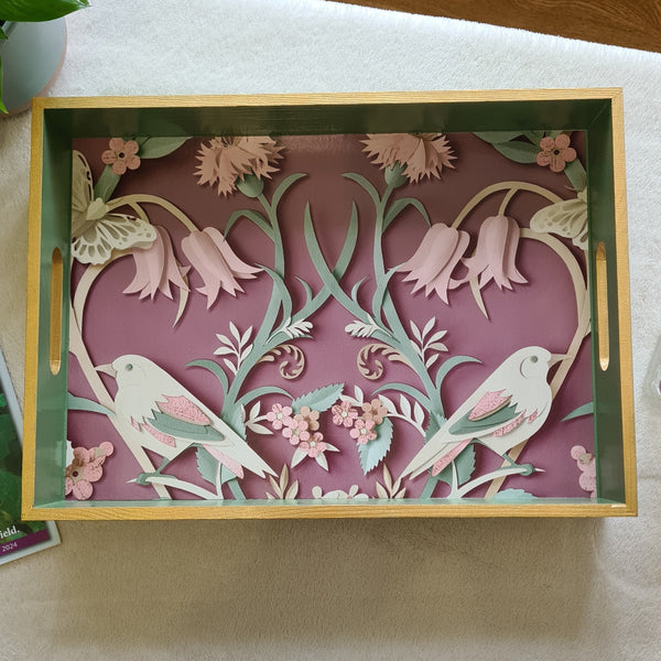 Handcrafted sage green wooden serving tray featuring symmetrical three-dimensional woodland birds design with trailing foliage.