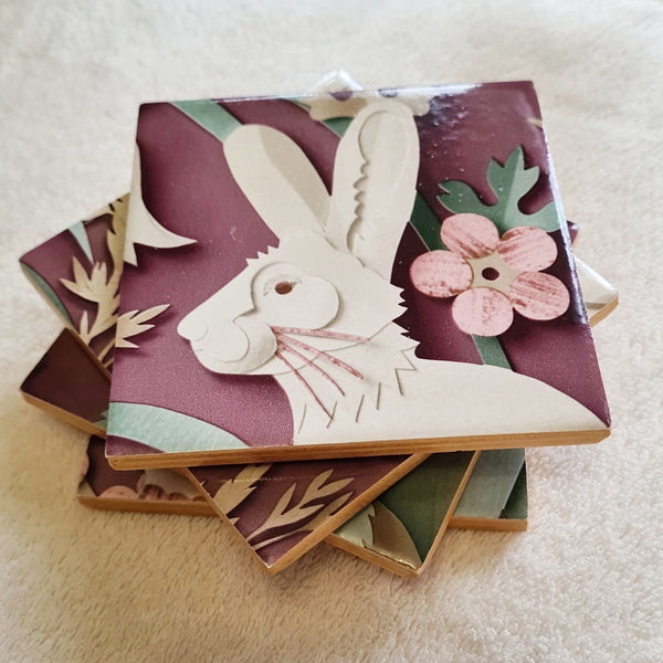 Handmade Woodland ceramic coaster featuring a hare amongst flowers and trailing foliage.