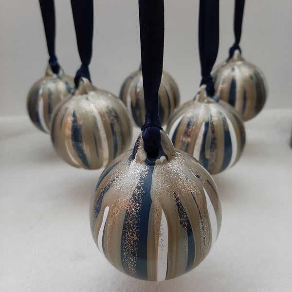Set of 6 uniquely painted Christmas baubles in blue, white, gold and glitter, strung with blue ribbon, hanging
