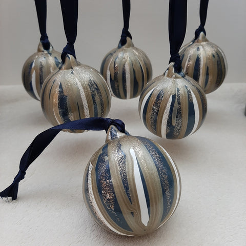 Set of 3 uniquely painted Christmas baubles in blue, white, gold and glitter, strung with blue ribbon, hanging 