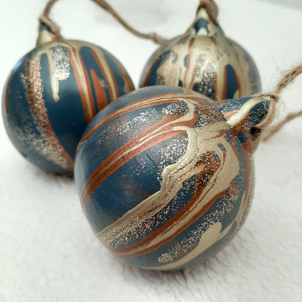 Set of 3 uniquely painted Christmas baubles in blue, copper, gold and glitter, strung with natural twine,
